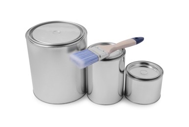 Photo of New metal paint can and brush on white background