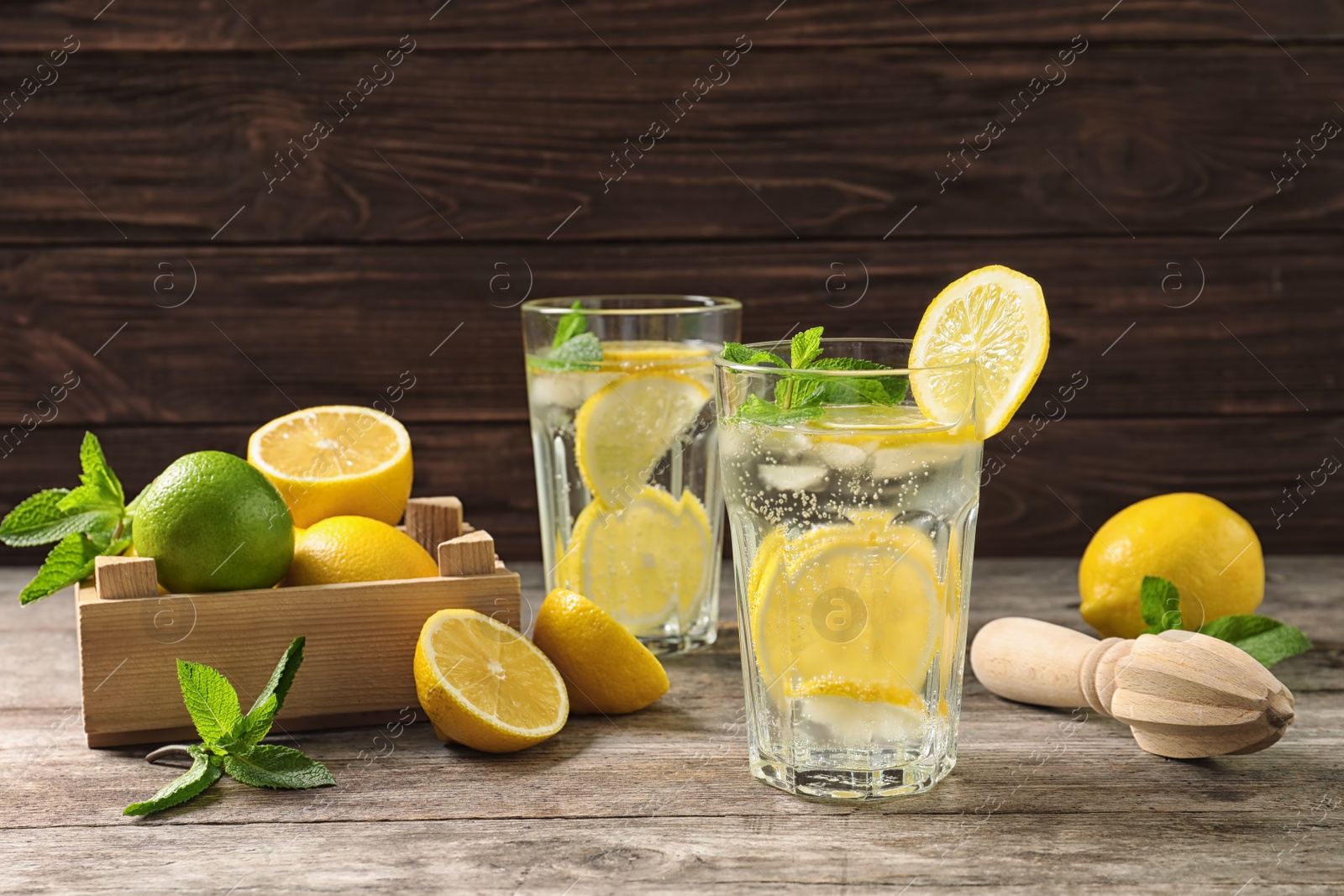 Photo of Glasses of natural lemonade with mint on table