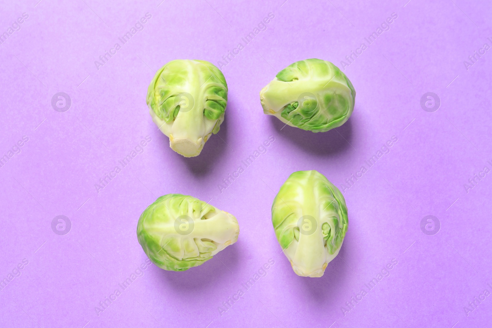 Photo of Fresh Brussels sprouts on color background, flat lay