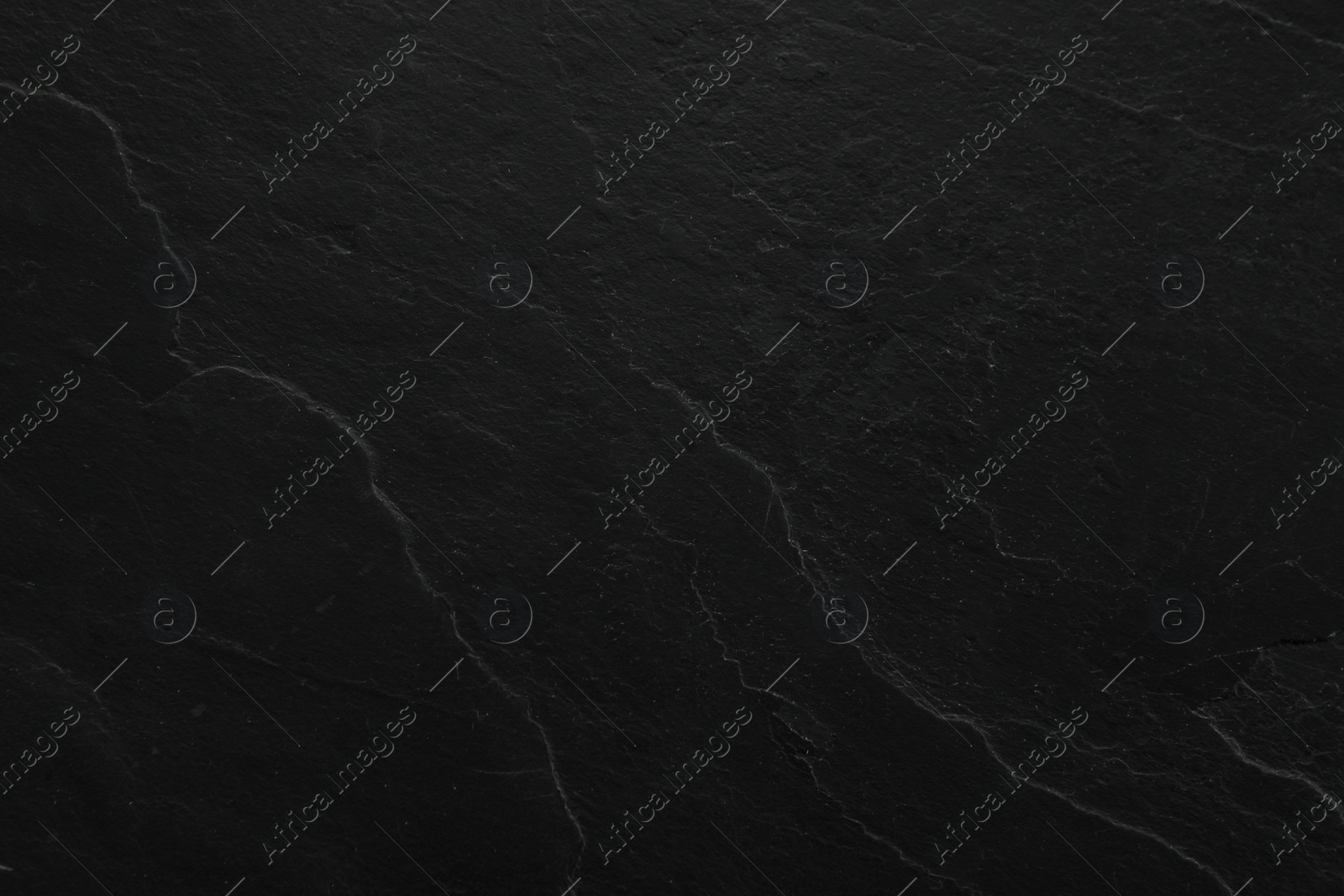 Photo of Texture of black stone surface as background, closeup