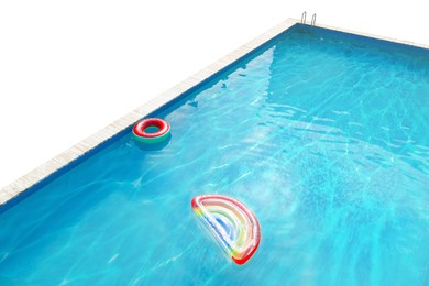 Image of Modern swimming pool with inflatable mattress and ring isolated on white