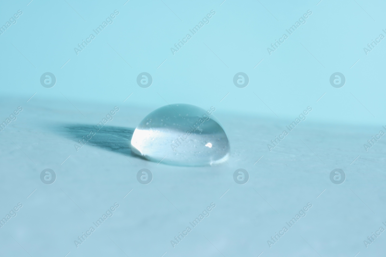 Photo of Macro photo of water drop on light blue background