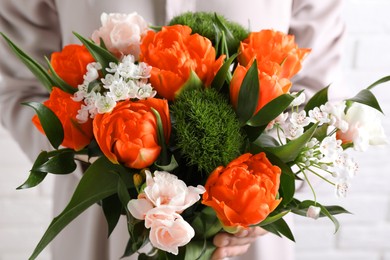 Image of Woman with bouquet of beautiful orange peony tulips, closeup