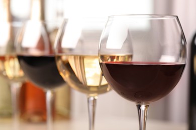 Photo of Different sorts of wine in glasses, closeup