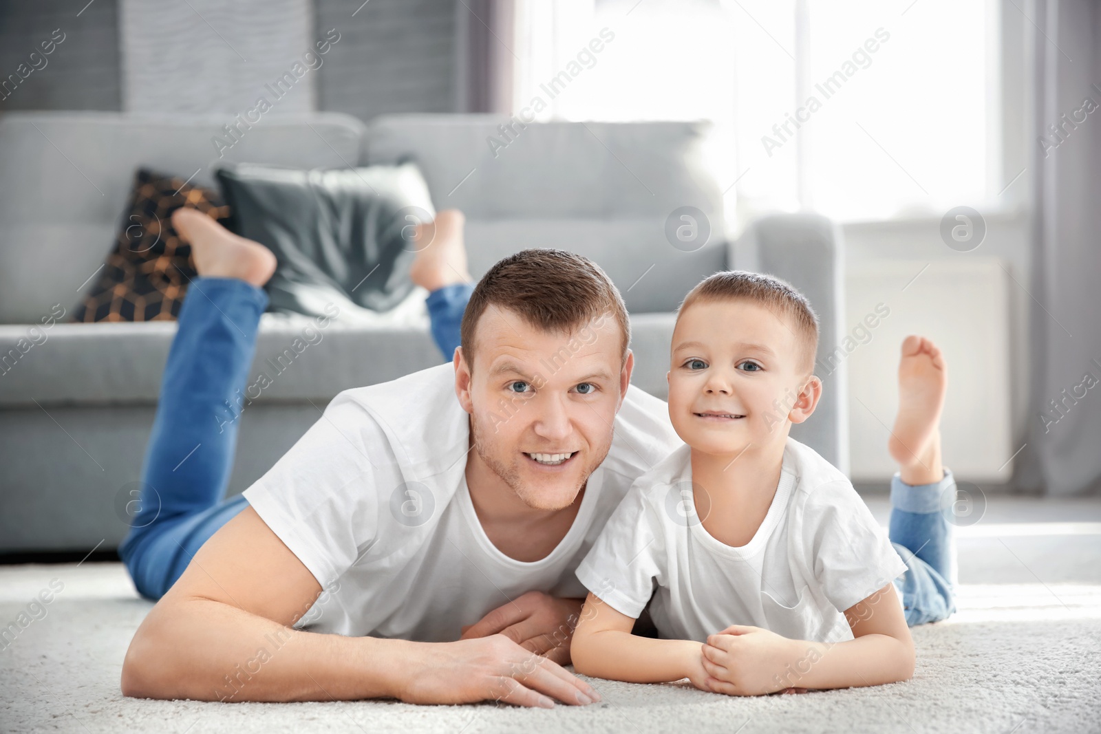 Photo of Happy dad and his son at home. Father's day celebration