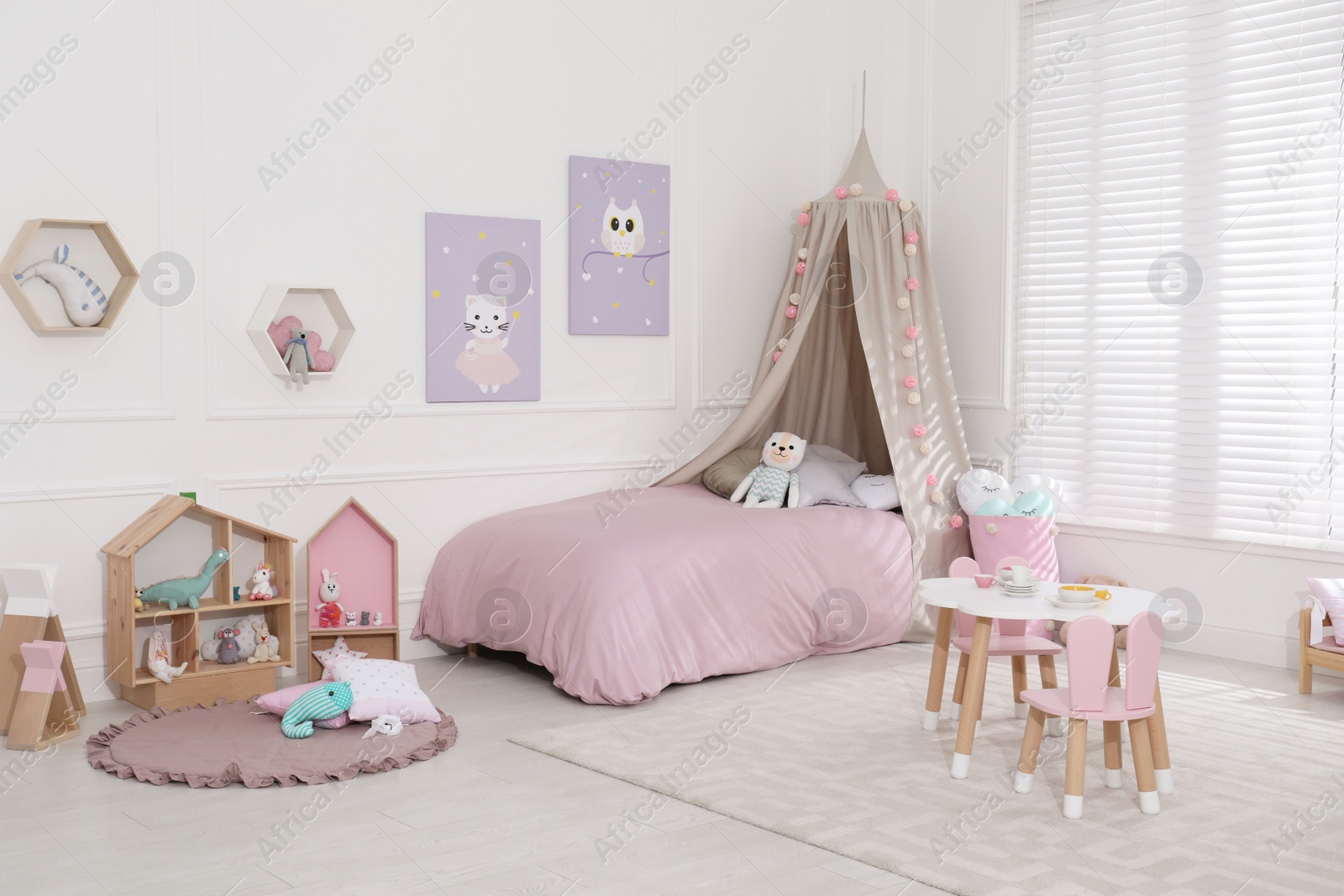 Photo of Cute child's room interior with toys and modern furniture