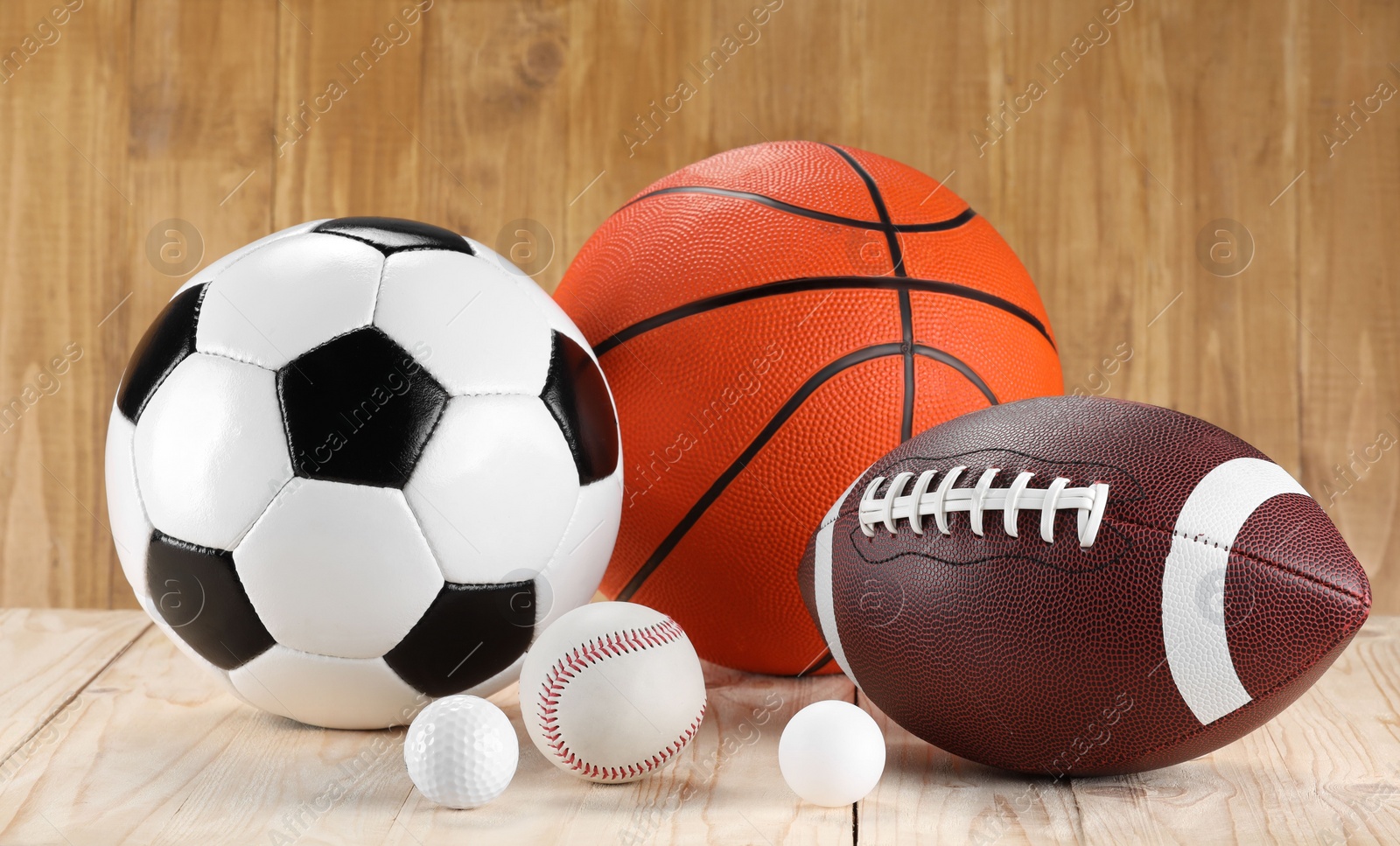 Photo of Many different sports balls on wooden background