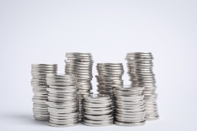 Photo of Many silver coins stacked on white background