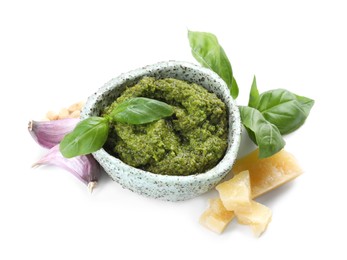 Photo of Fresh tasty pesto sauce and ingredients isolated on white