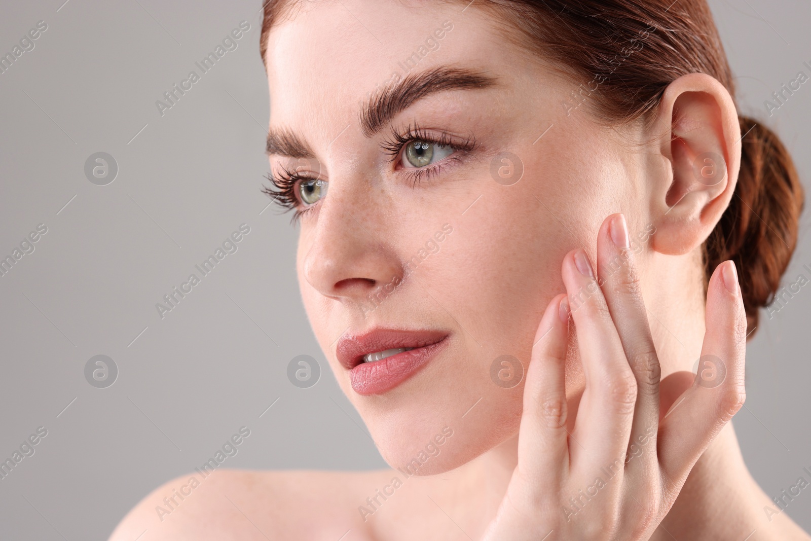 Photo of Portrait of beautiful woman on grey background, closeup