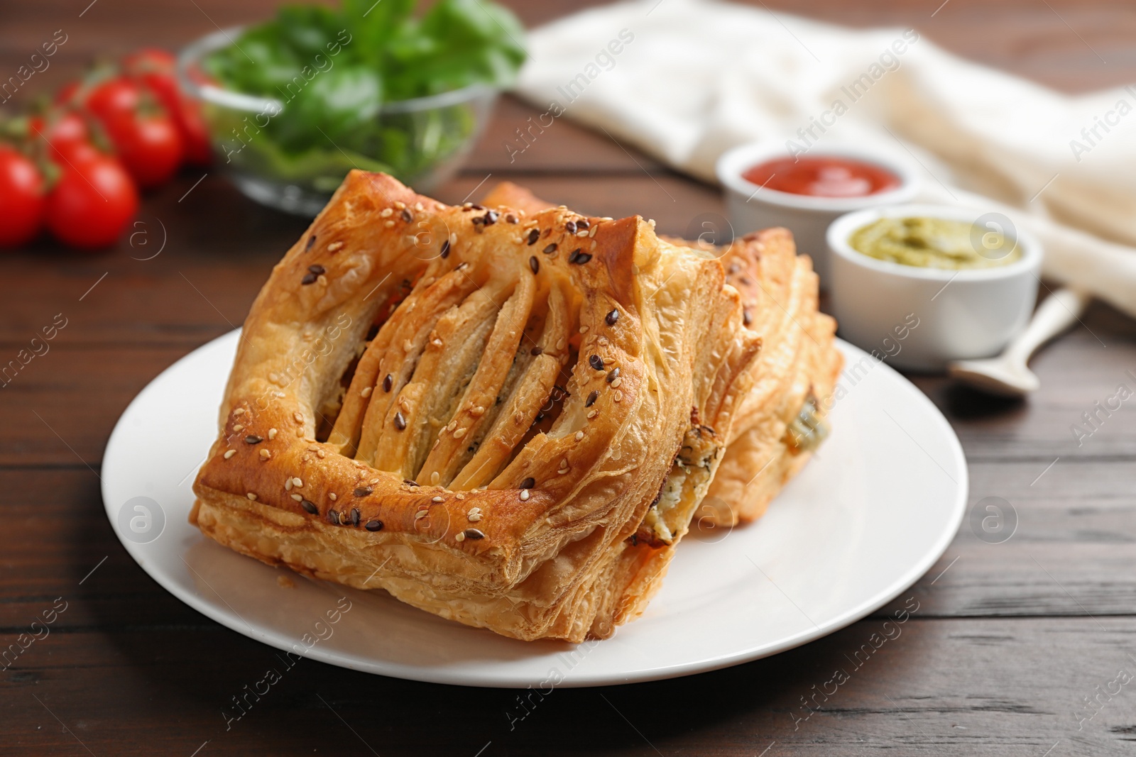 Photo of Fresh delicious puff pastry served on wooden table