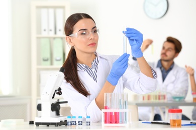 Female scientist working at table in laboratory. Research and analysis