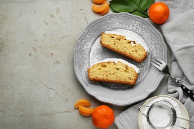 Delicious homemade yogurt cake with tangerines and powdered sugar on gray table, flat lay. Space for text