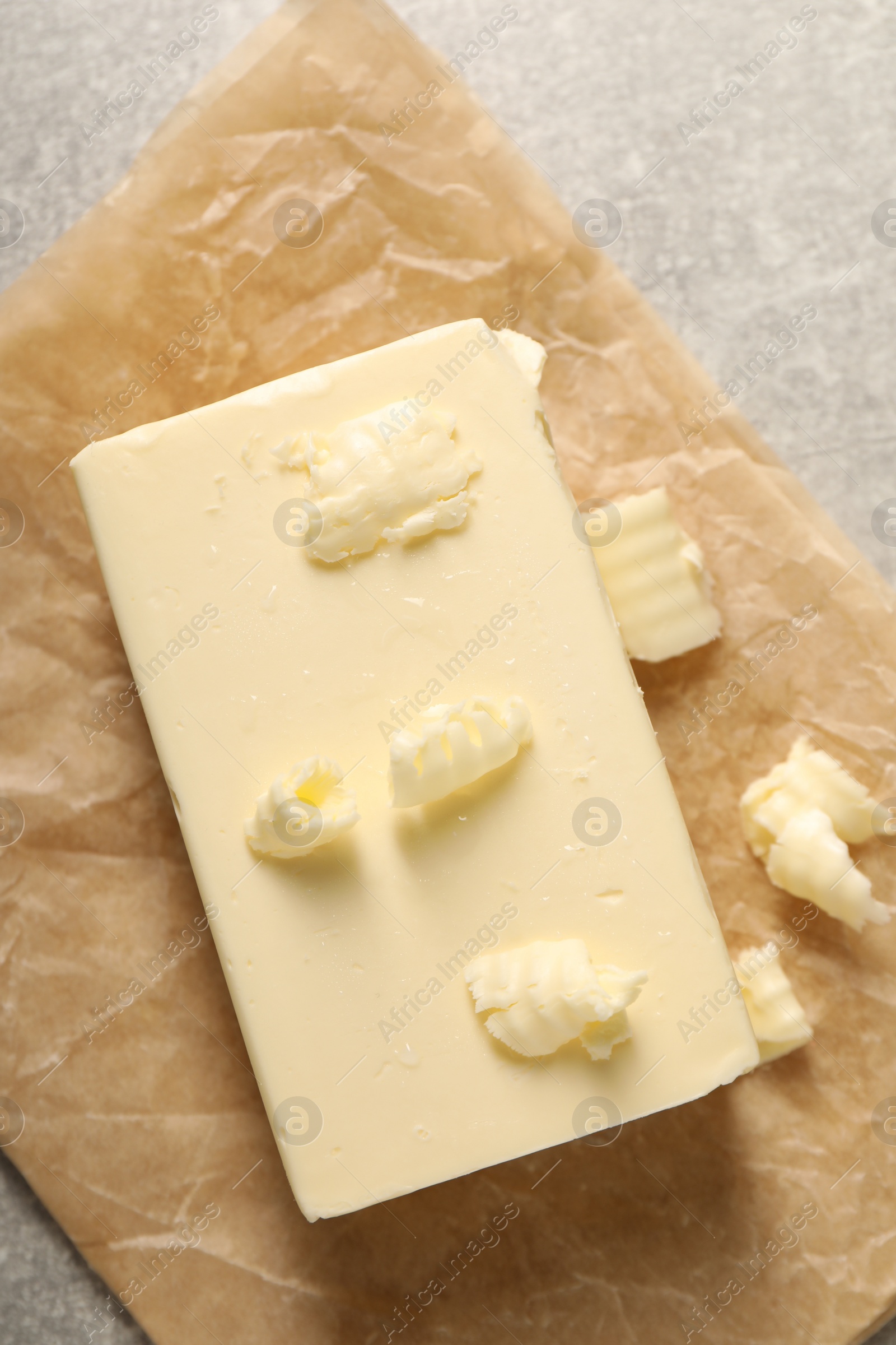 Photo of Tasty butter on grey table, top view