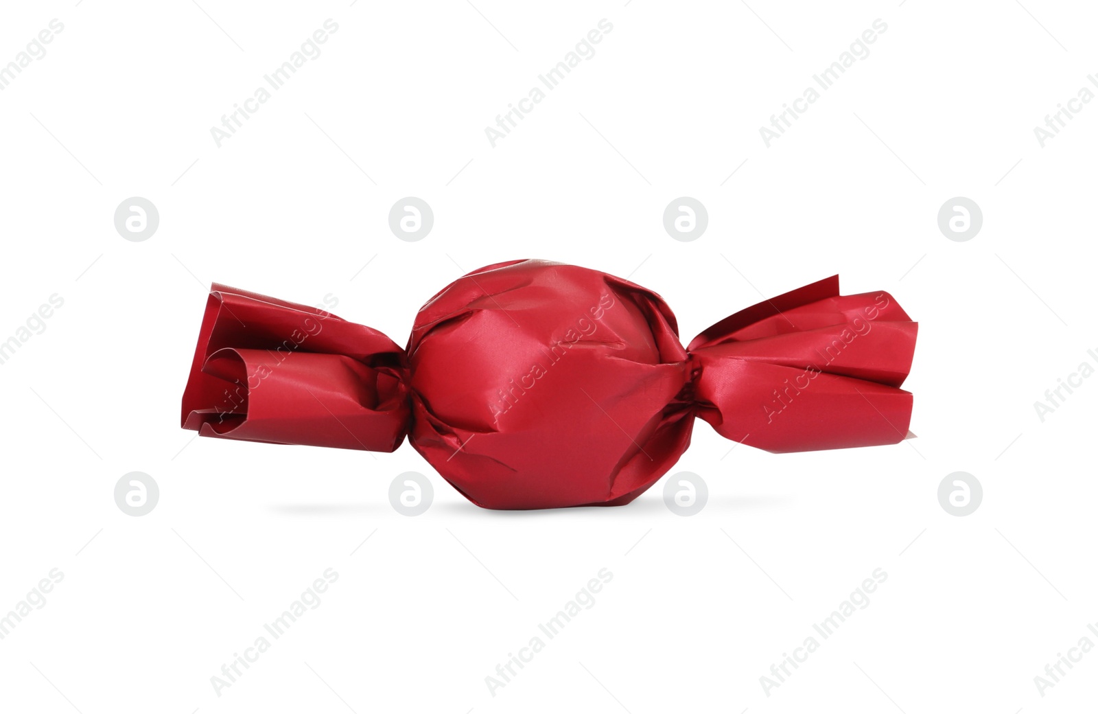 Photo of Delicious candy in red wrapper isolated on white