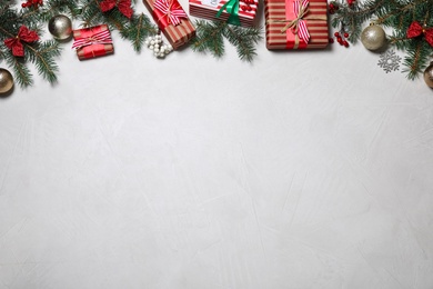 Photo of Flat lay composition of color Christmas gift boxes on light background. Space for text