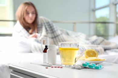 Photo of Different cold remedies and sick woman on background