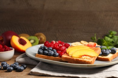 Tasty toasts with different spreads and fruits on wooden table