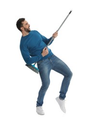 Man with broom having fun on white background