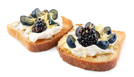 Photo of Tasty sandwiches with cream cheese, blueberries, blackberries and lemon zest on white background