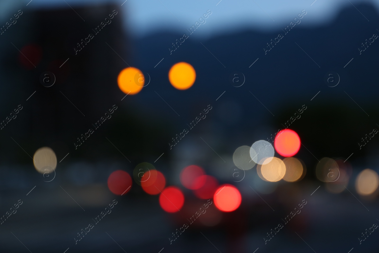 Photo of Blurred view of modern city and road with cars. Bokeh effect