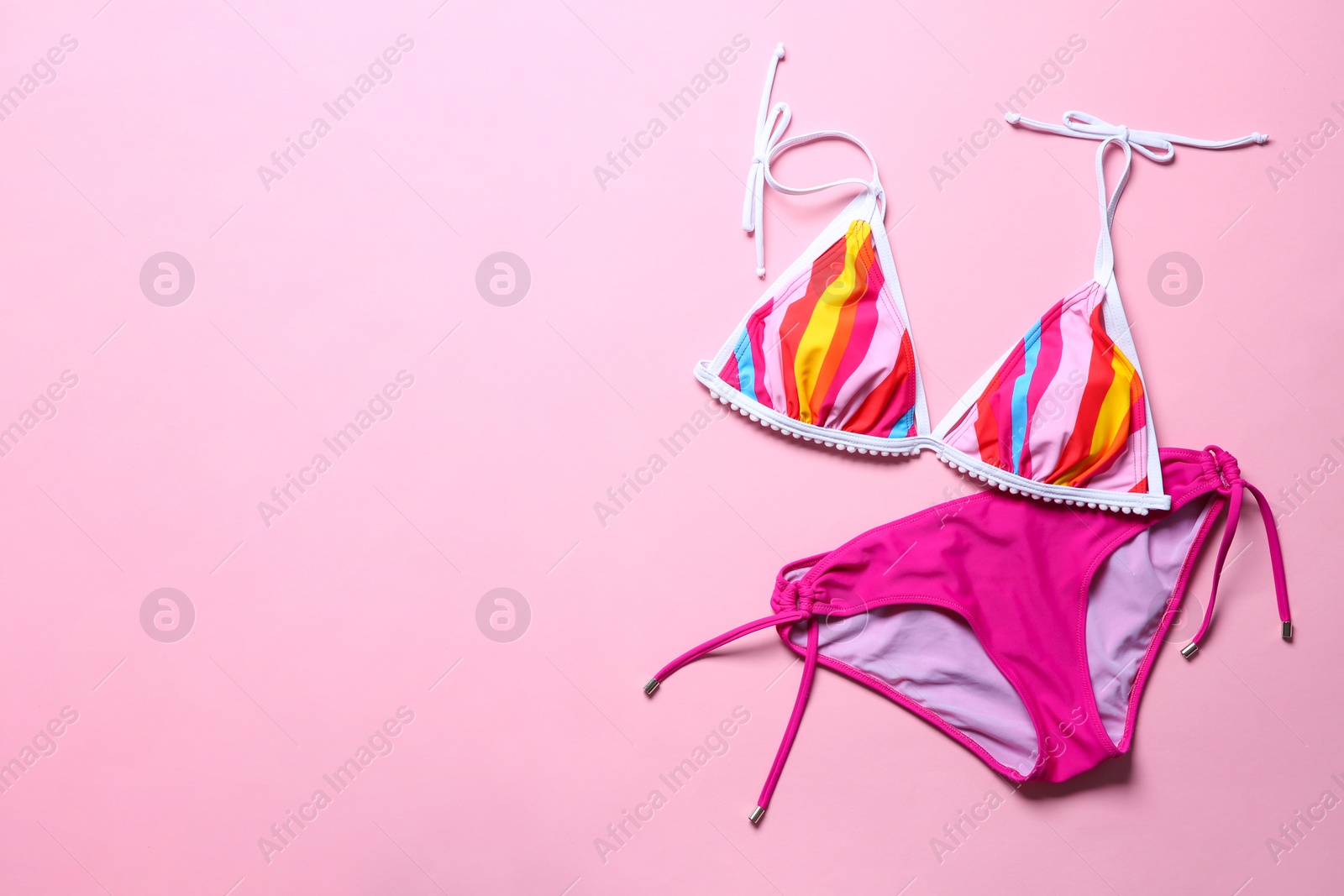 Photo of Stylish bikini on color background, top view