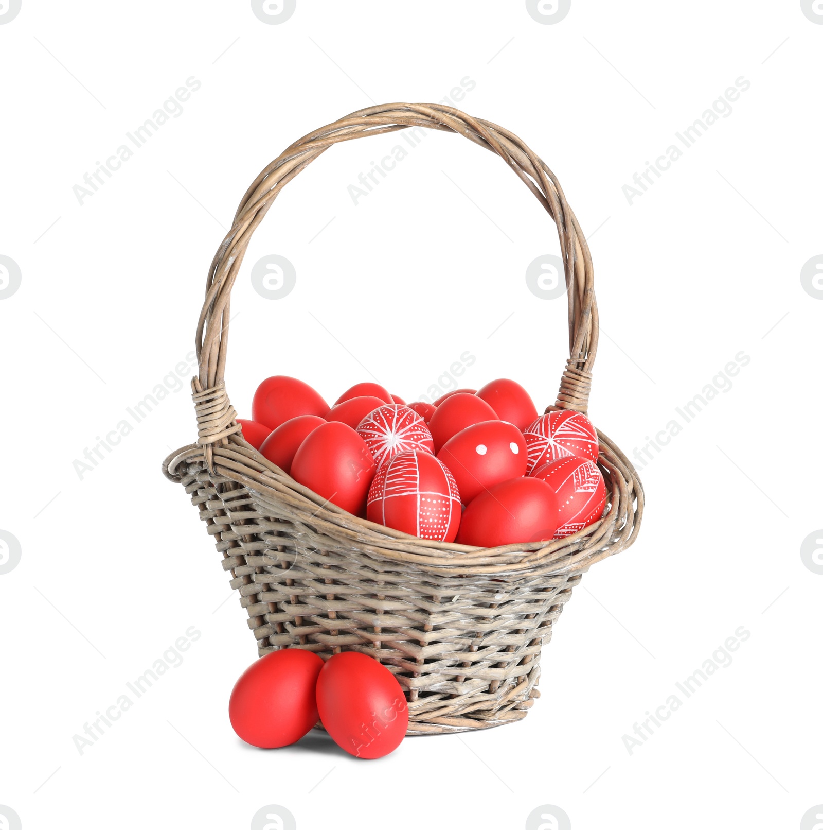 Photo of Wicker basket with painted red Easter eggs on white background