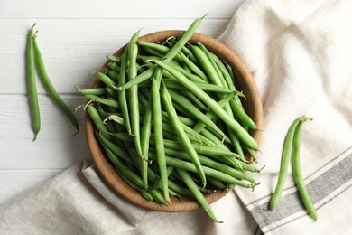 Photo of Fresh green beans on white wooden table, flat lay