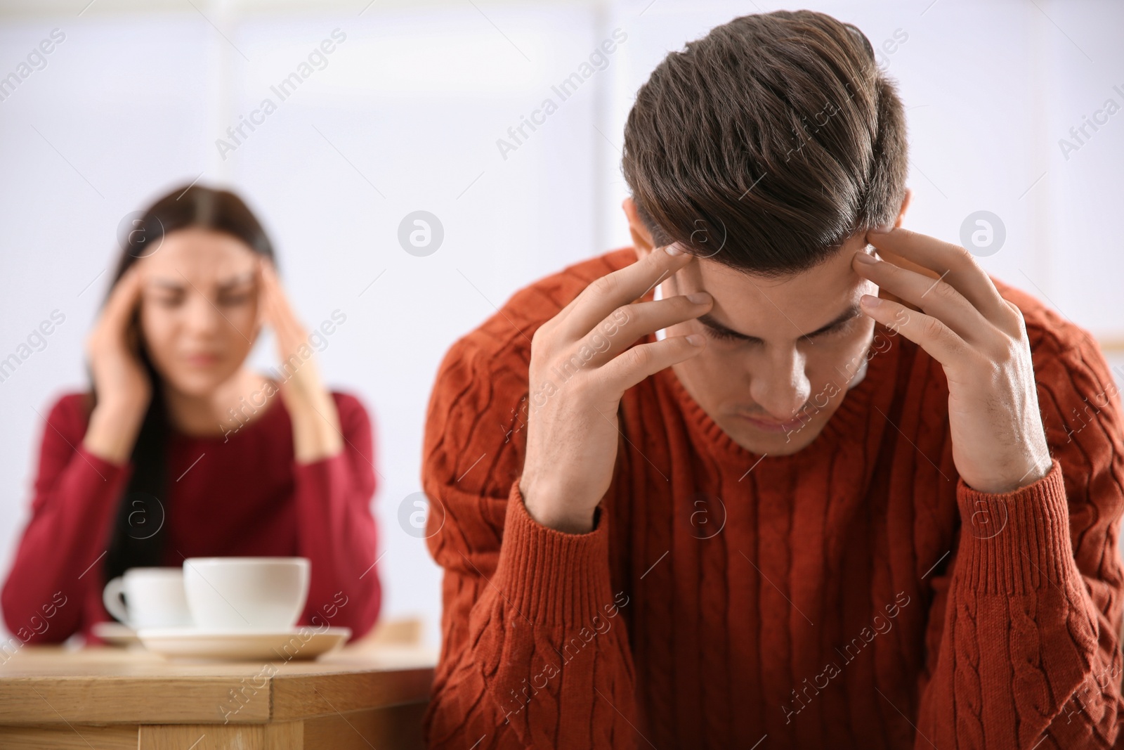 Photo of Couple with relationship problems at table in cafe