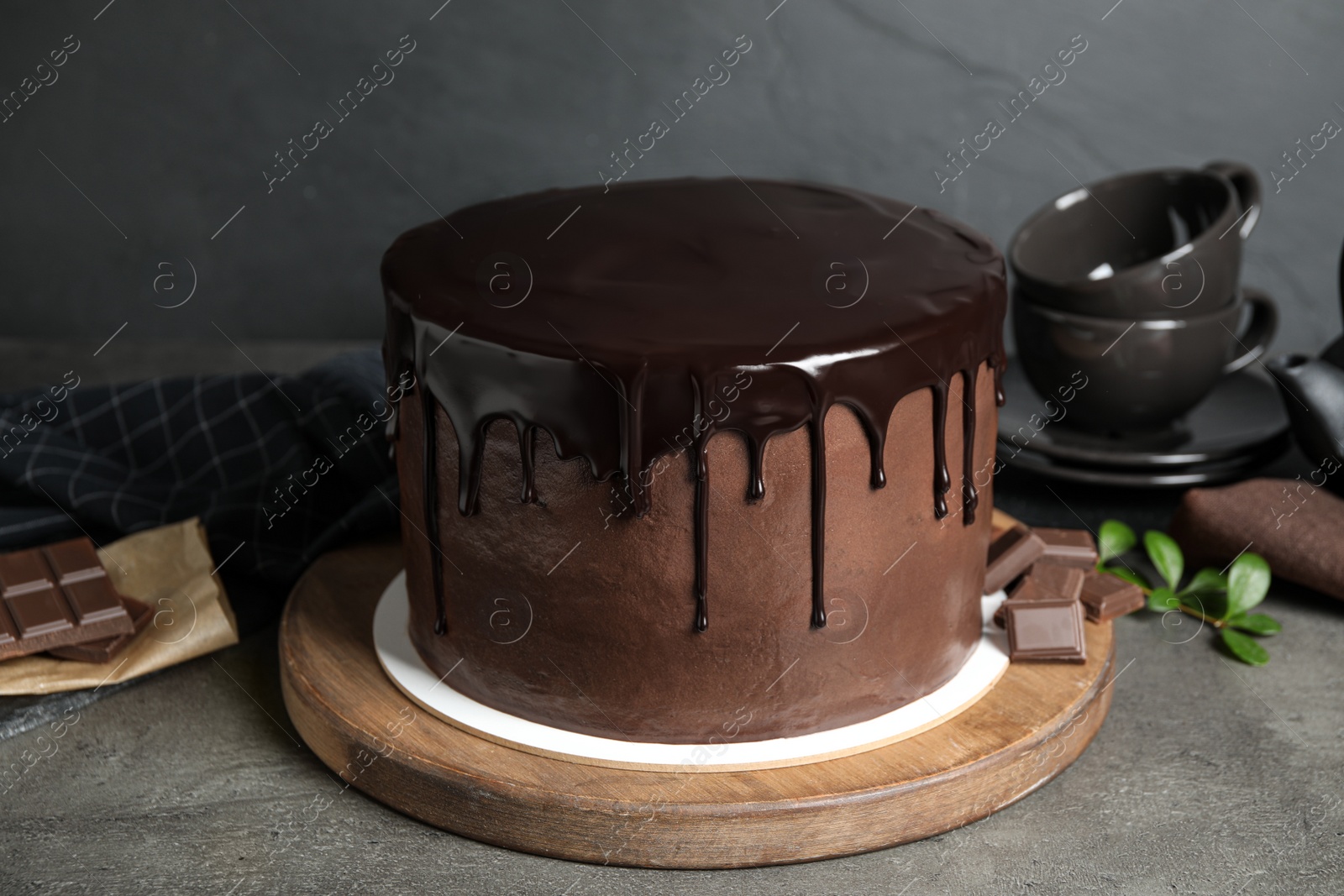 Photo of Freshly made delicious chocolate cake on grey table