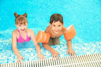 Photo of Happy children resting together in swimming pool