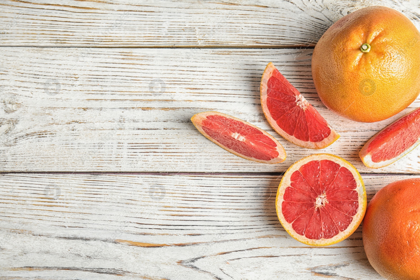 Photo of Flat lay composition with grapefruits and space for text on wooden background