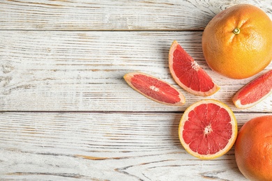 Flat lay composition with grapefruits and space for text on wooden background