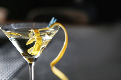 Photo of Glass of lemon drop martini cocktail in bar, closeup. Space for text