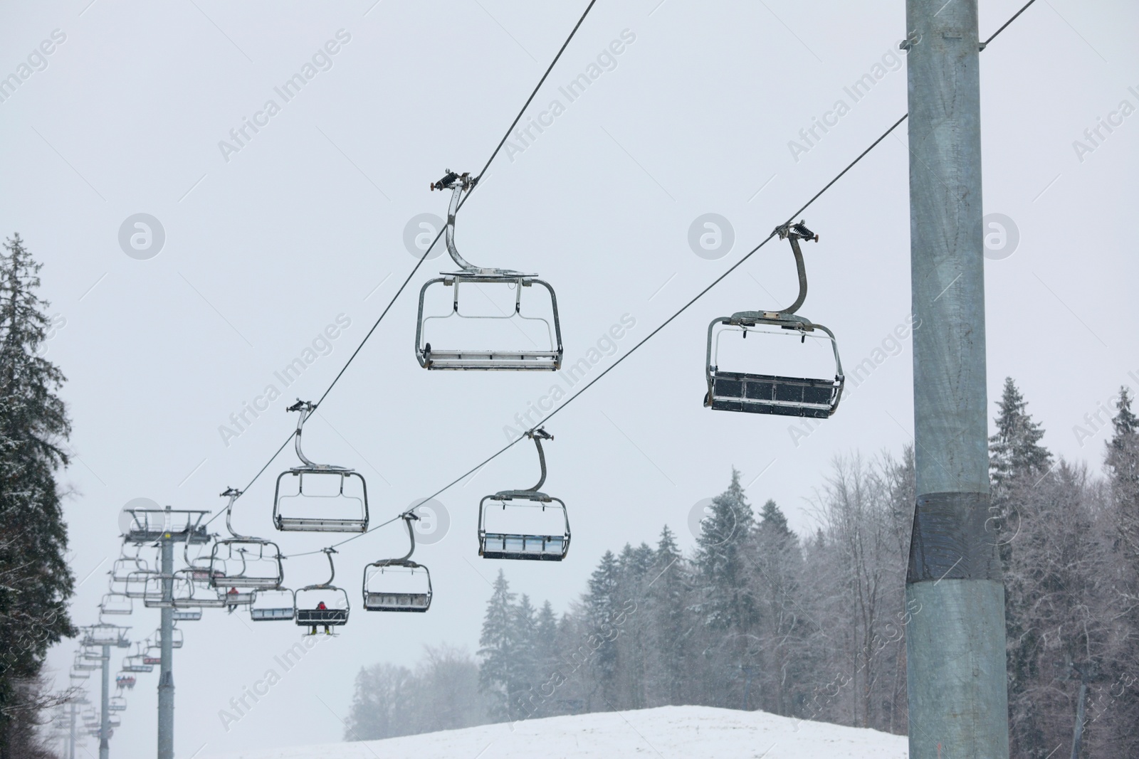 Photo of Ski lift at mountain resort. Winter vacation