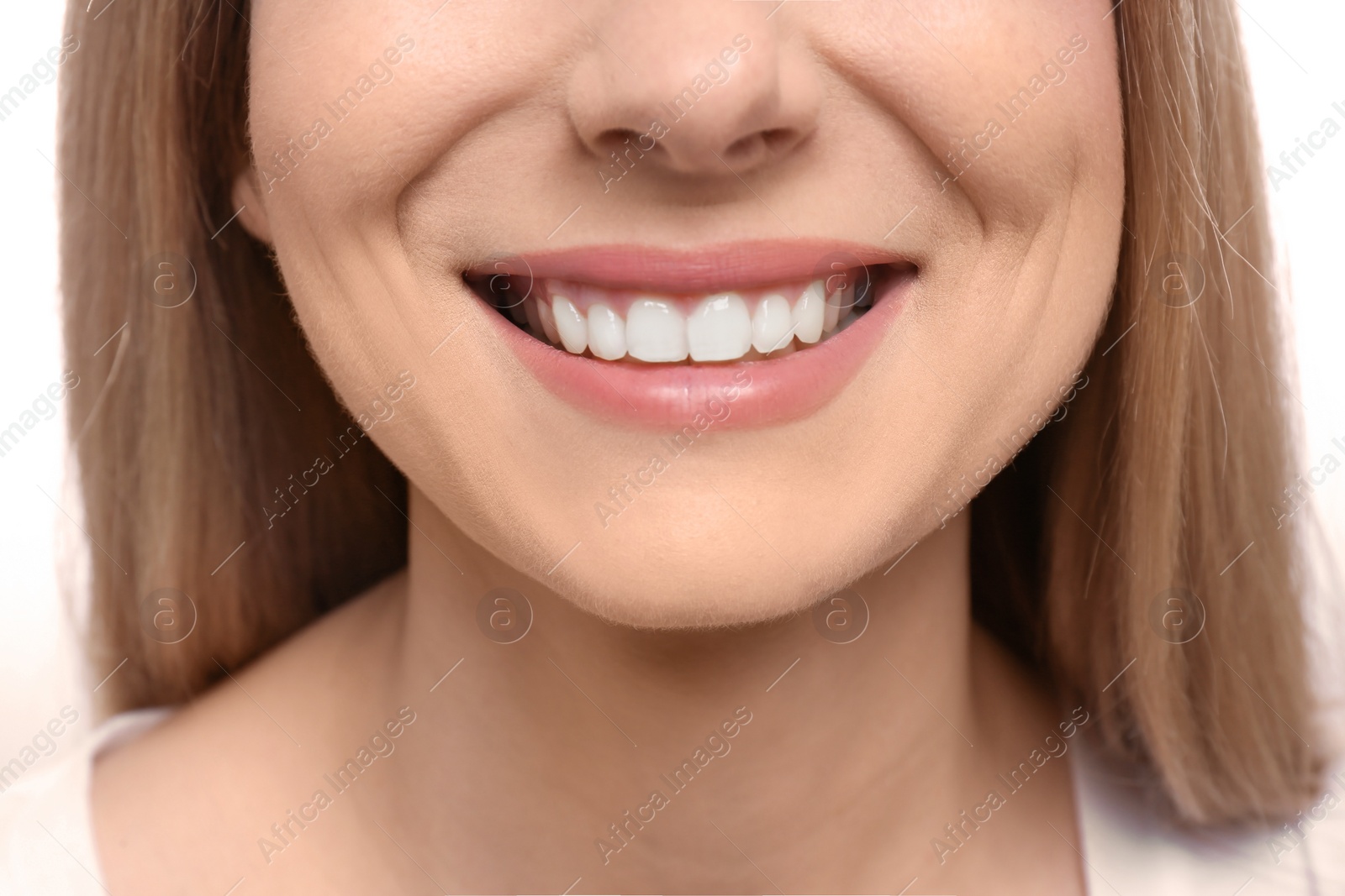 Photo of Young woman with beautiful smile, closeup. Teeth whitening