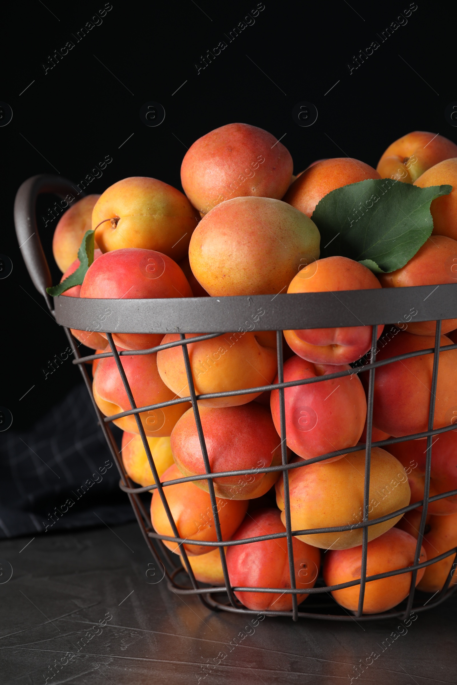 Photo of Delicious fresh ripe apricots on grey table