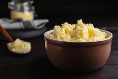 Photo of Bowl of Ghee butter on wooden table, closeup