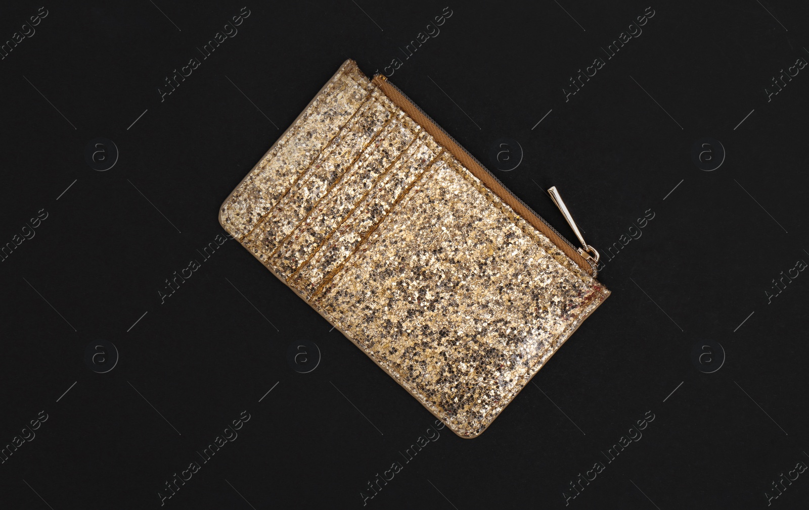 Photo of Elegant shining gold purse on black background, top view