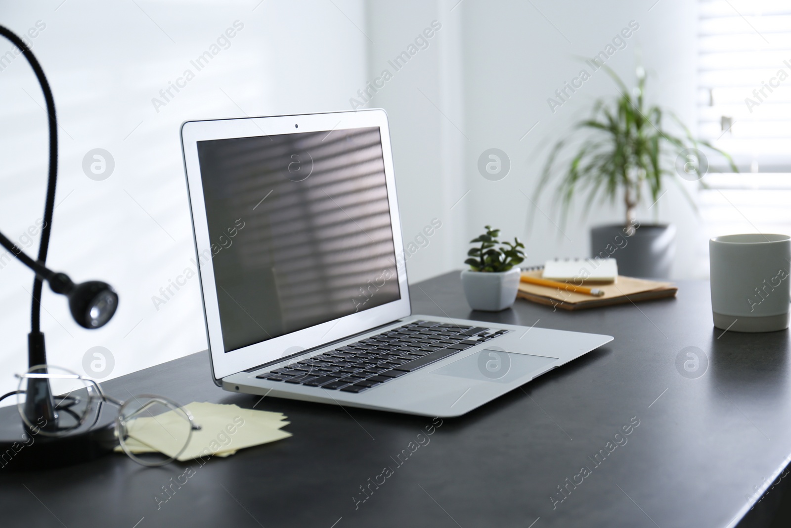 Photo of Modern laptop on office table. Stylish workplace