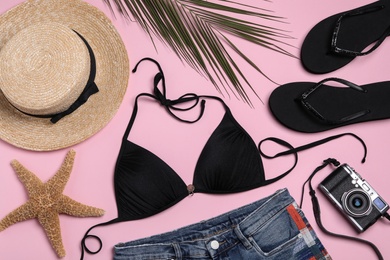 Photo of Flat lay composition with stylish beach accessories on pink background