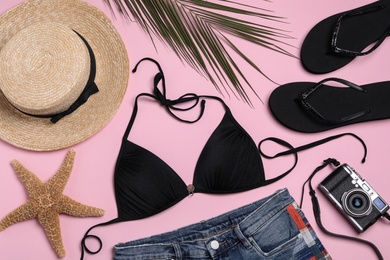 Flat lay composition with stylish beach accessories on pink background