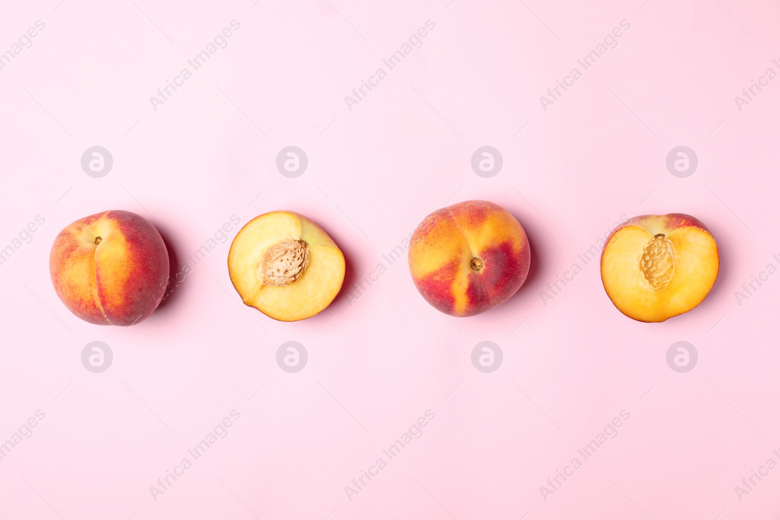 Photo of Sweet juicy peaches on pink background, top view