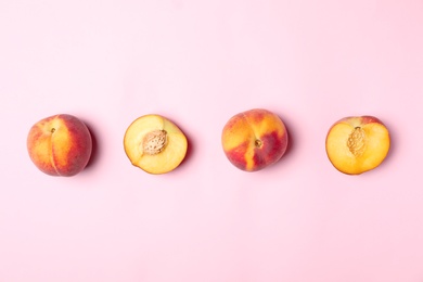 Sweet juicy peaches on pink background, top view