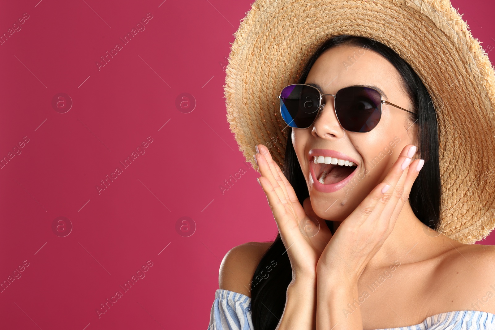 Photo of Excited woman wearing sunglasses on pink background. Space for text