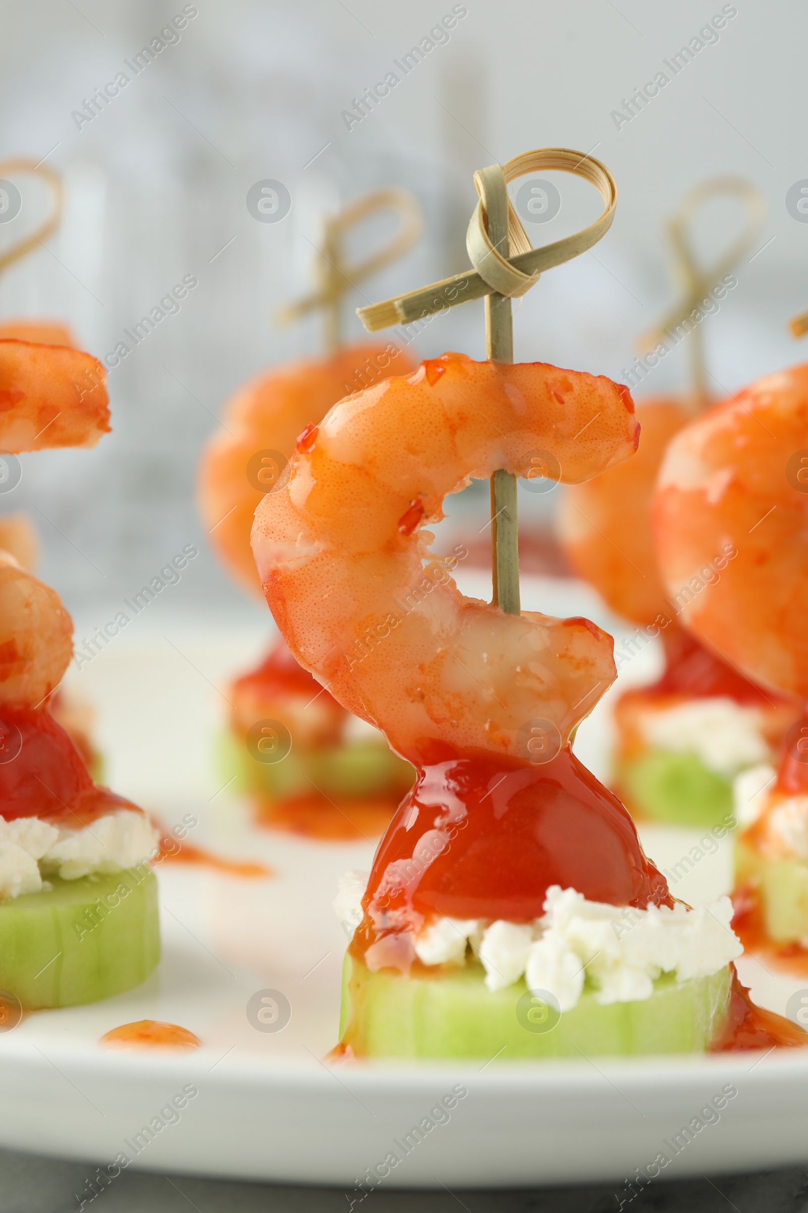 Photo of Tasty canapes with shrimps, vegetables and cream cheese on white table, closeup