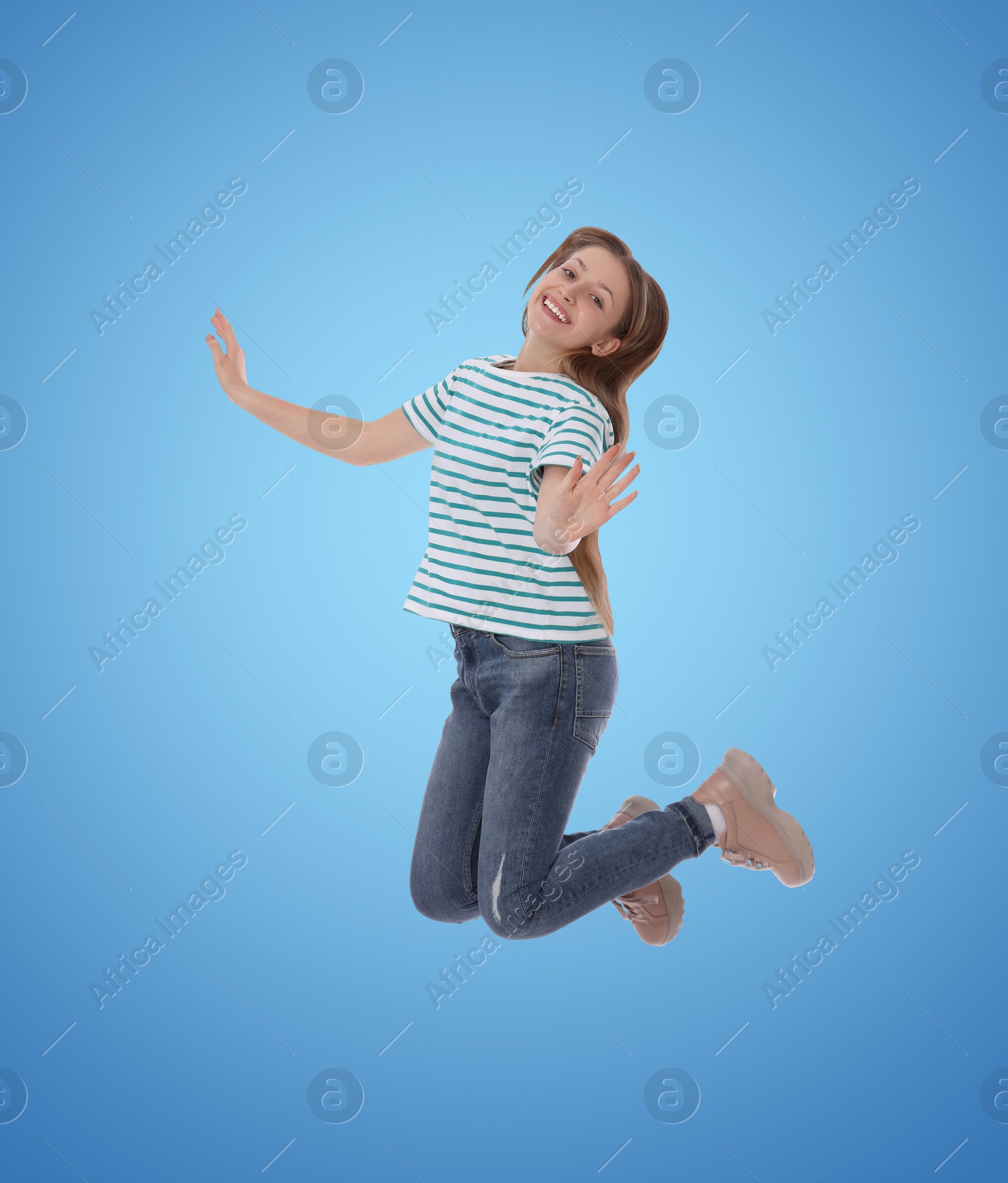 Image of Happy cute girl jumping on color gradient background