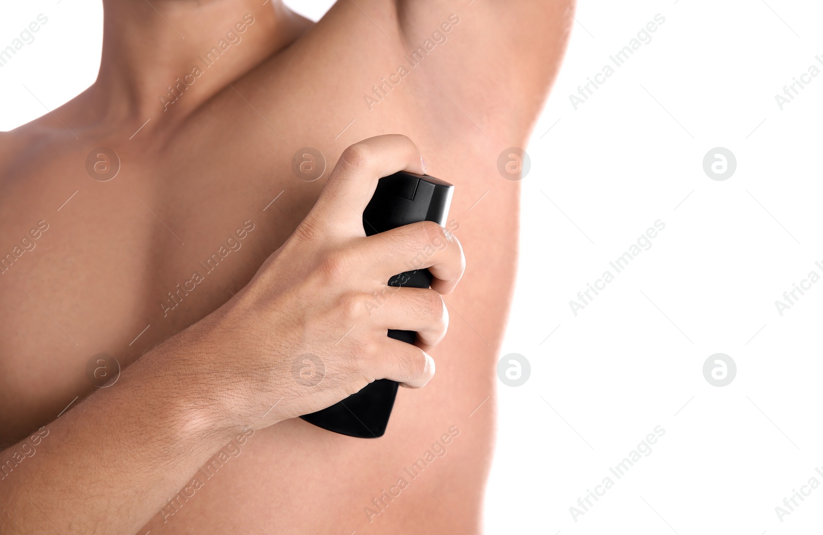 Photo of Young man using deodorant on white background, closeup. Space for text