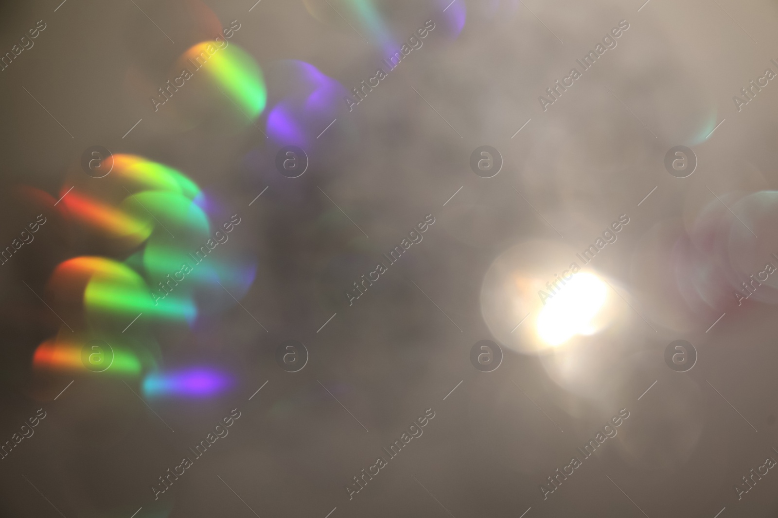 Photo of Blurred view of shiny lights on light background. Bokeh effect