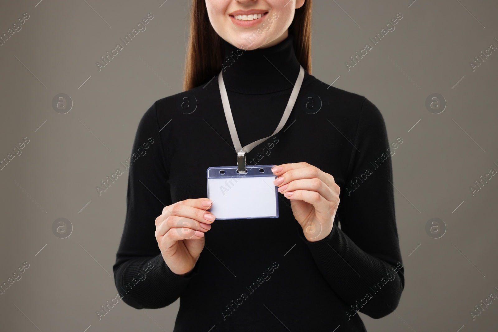 Photo of Woman with blank badge on grey background, closeup